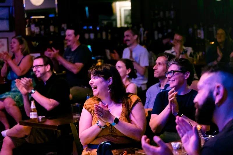 The audience applauding in the bar