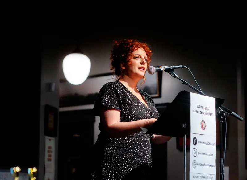 A combatant at the lectern under a warm lamp